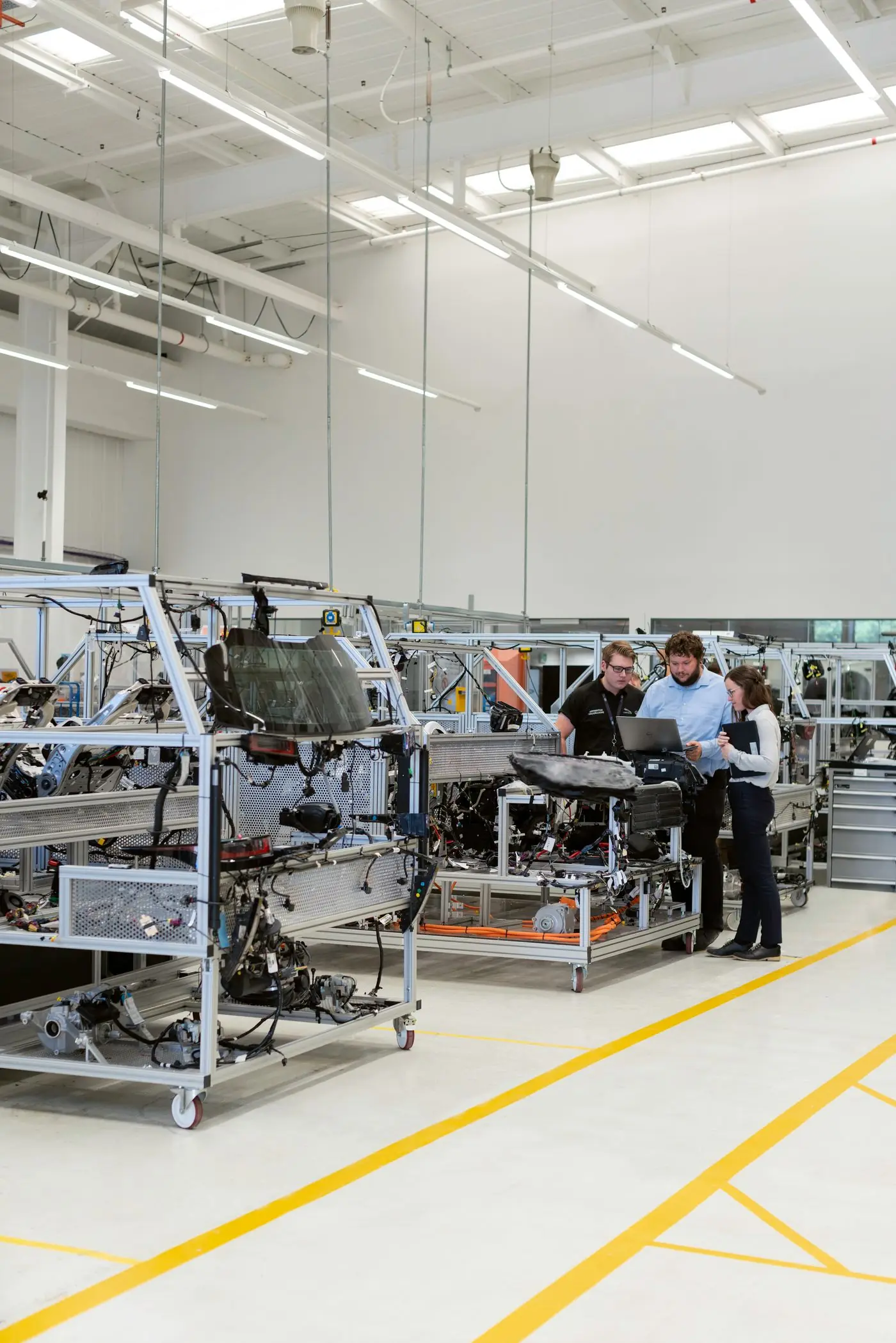 Engineers working with a laptop during industrial commissioning